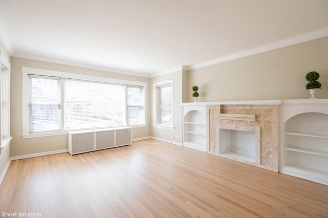2614 W Lunt Ave, Chicago, IL 60645 - unfurnished living room with radiator, wood finished floors, ornamental molding, built in features, and a fireplace