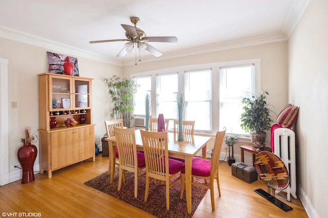 2614 W Lunt Ave, Chicago, IL 60645 - dining area featuring light wood-style floors, radiator, ornamental molding, and ceiling fan