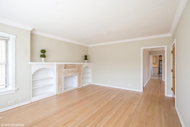 2614 W Lunt Ave, Chicago, IL 60645 - unfurnished living room featuring light wood finished floors, plenty of natural light, crown molding, a fireplace, and built in features