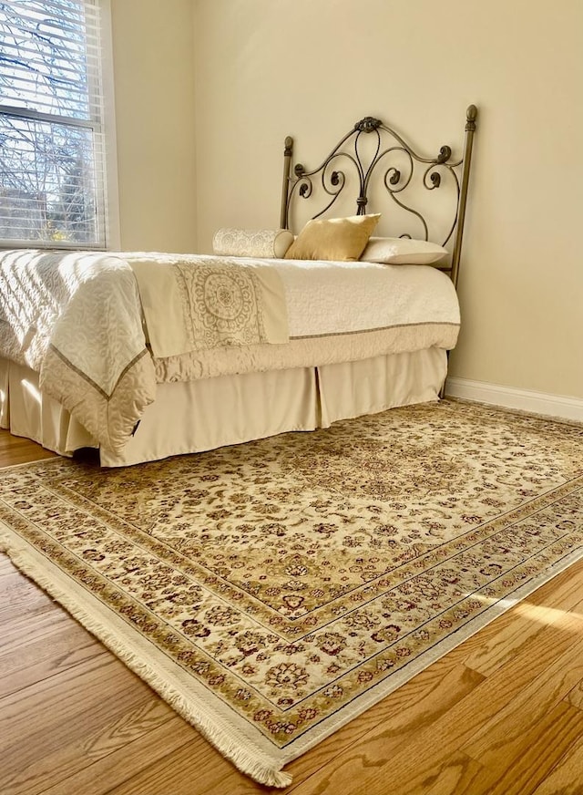 2614 W Lunt Ave, Chicago, IL 60645 - bedroom with baseboards and wood finished floors