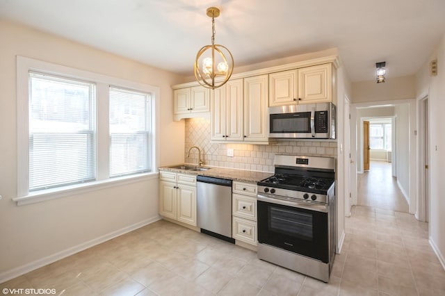 2614 W Lunt Ave, Chicago, IL 60645 - kitchen with stainless steel appliances, backsplash, cream cabinetry, and light tile patterned flooring
