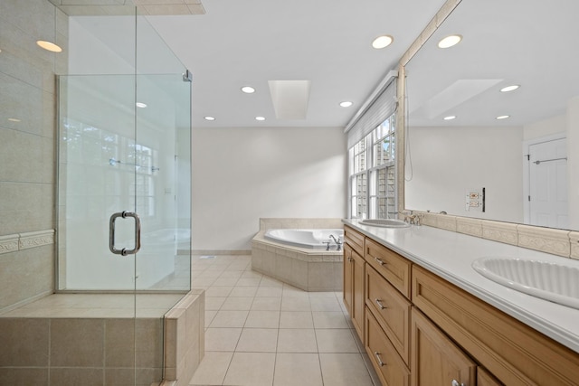 572 Stockbridge Ct, Lake Forest, IL 60045 - bathroom with tile patterned flooring, a bath, double vanity, a shower stall, and recessed lighting