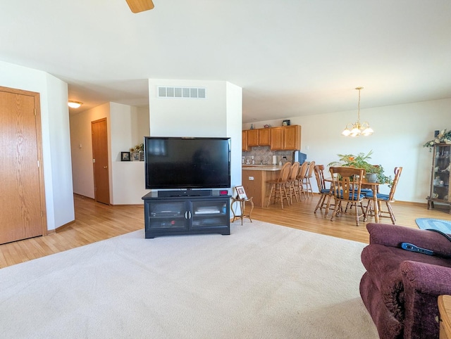5710 Hearthside Dr, Bourbonnais, IL 60914 - living area with a chandelier, light wood finished floors, and a ceiling fan