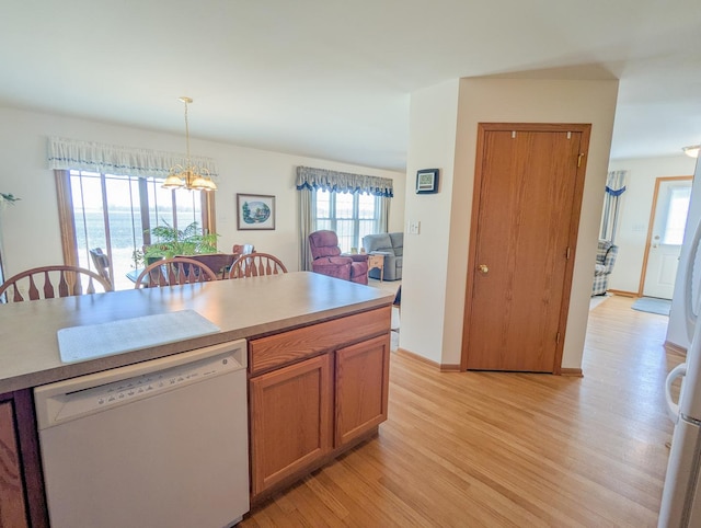 5710 Hearthside Dr, Bourbonnais, IL 60914 - kitchen featuring white dishwasher, light wood finished floors, a chandelier, and plenty of natural light
