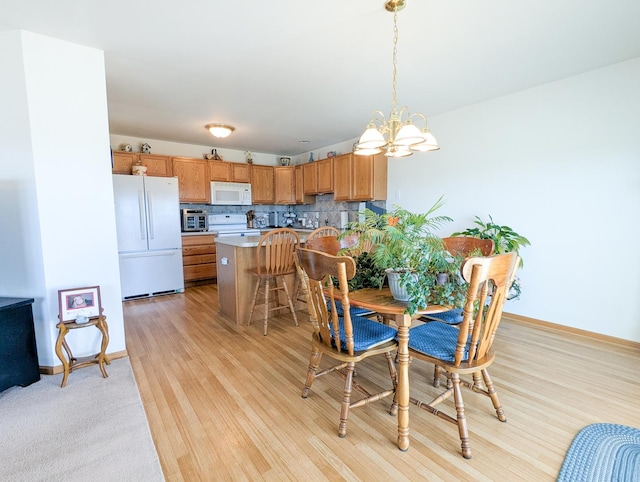 5710 Hearthside Dr, Bourbonnais, IL 60914 - dining area featuring a chandelier and light wood-style floors