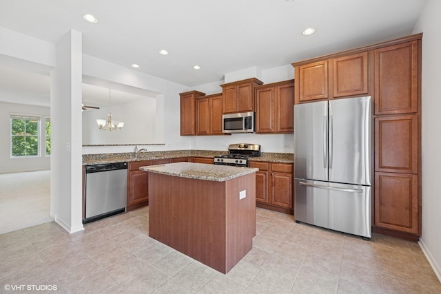 208 W Hyde St, Arlington Heights, IL 60005 - kitchen with appliances with stainless steel finishes, recessed lighting, brown cabinets, a kitchen island, and a chandelier