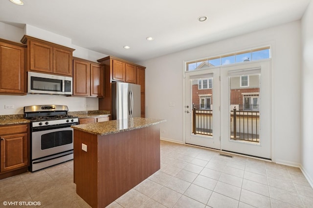 208 W Hyde St, Arlington Heights, IL 60005 - kitchen featuring stainless steel appliances, a center island, brown cabinetry, dark stone countertops, and recessed lighting