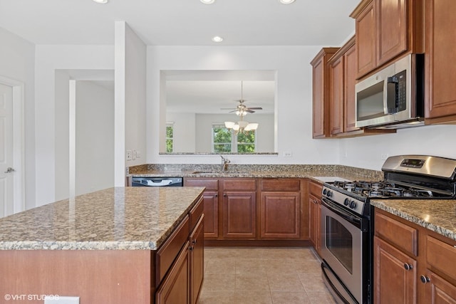 208 W Hyde St, Arlington Heights, IL 60005 - kitchen featuring appliances with stainless steel finishes, a center island, light tile patterned floors, brown cabinets, and ceiling fan