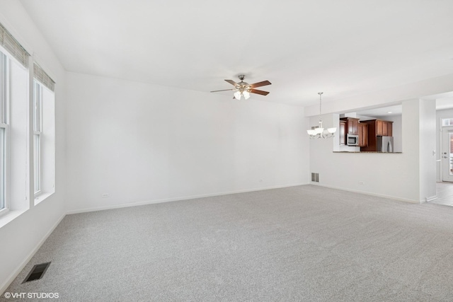 208 W Hyde St, Arlington Heights, IL 60005 - unfurnished living room featuring a ceiling fan, a chandelier, and light carpet