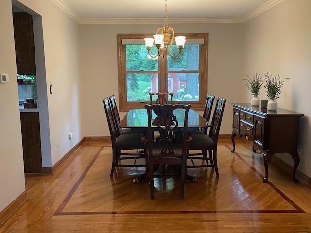 10S305 Havens Dr, Downers Grove, IL 60516 - dining area featuring a chandelier, ornamental molding, and wood finished floors