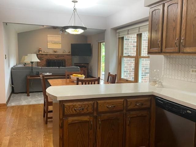 10S305 Havens Dr, Downers Grove, IL 60516 - kitchen with dishwasher, a peninsula, a fireplace, light wood finished floors, and light countertops