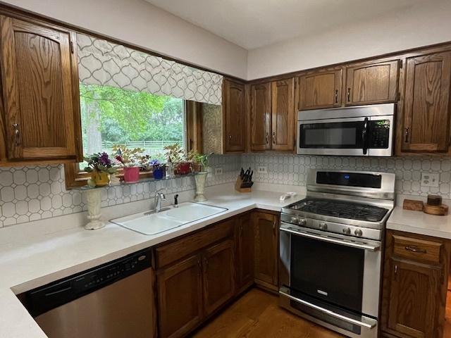 10S305 Havens Dr, Downers Grove, IL 60516 - kitchen featuring appliances with stainless steel finishes, light countertops, and backsplash