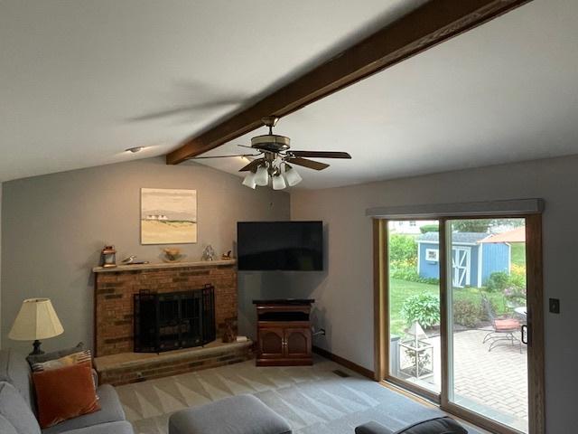 10S305 Havens Dr, Downers Grove, IL 60516 - living area with light colored carpet, ceiling fan, and a brick fireplace