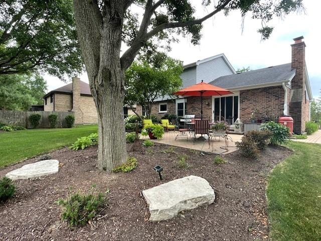 10S305 Havens Dr, Downers Grove, IL 60516 - rear view of property featuring a patio area, brick siding, and a chimney
