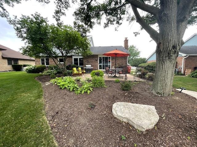 10S305 Havens Dr, Downers Grove, IL 60516 - back of house with a patio area, brick siding, a yard, and a chimney