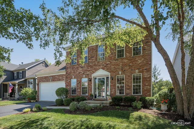 39W183 E Burnham Ln, Geneva, IL 60134 - view of front of home featuring brick siding, driveway, a garage, and a front yard