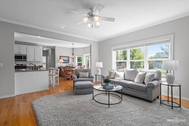 39W183 E Burnham Ln, Geneva, IL 60134 - living room featuring light wood-style floors, crown molding, ceiling fan, and a chandelier