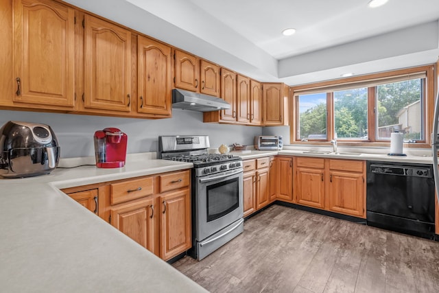 35W186 Duchesne Dr, Dundee, IL 60118 - kitchen with gas stove, black dishwasher, under cabinet range hood, light wood-style flooring, and light countertops