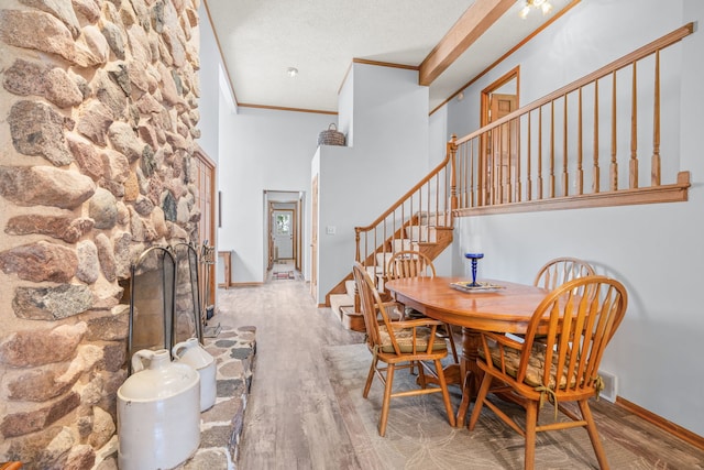 35W186 Duchesne Dr, Dundee, IL 60118 - dining room featuring ornamental molding, wood finished floors, a high ceiling, stairs, and a fireplace
