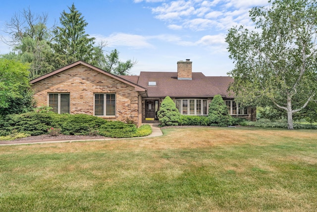 35W186 Duchesne Dr, Dundee, IL 60118 - view of front of house with brick siding, a front lawn, and a chimney