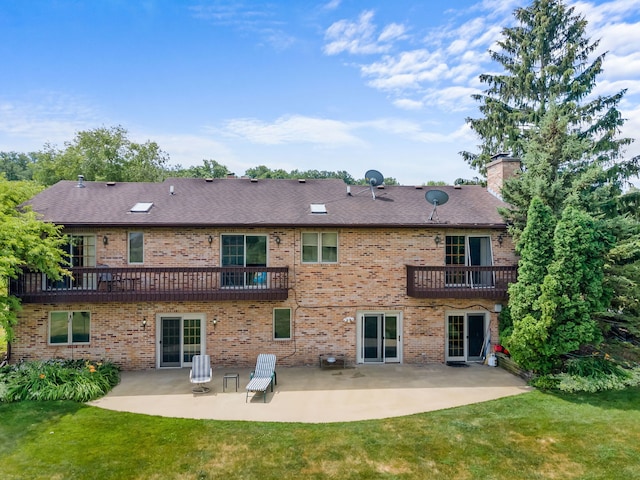 35W186 Duchesne Dr, Dundee, IL 60118 - rear view of property featuring a balcony, a patio, brick siding, a yard, and a chimney