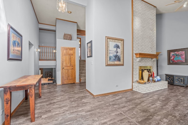 35W186 Duchesne Dr, Dundee, IL 60118 - living area with a high ceiling, a brick fireplace, wood finished floors, stairs, and a chandelier