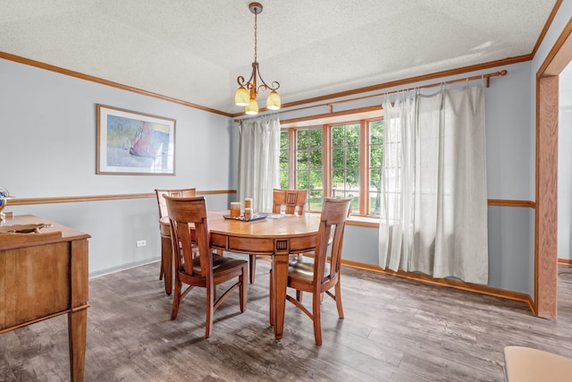 35W186 Duchesne Dr, Dundee, IL 60118 - dining room featuring ornamental molding, a textured ceiling, wood finished floors, and a chandelier