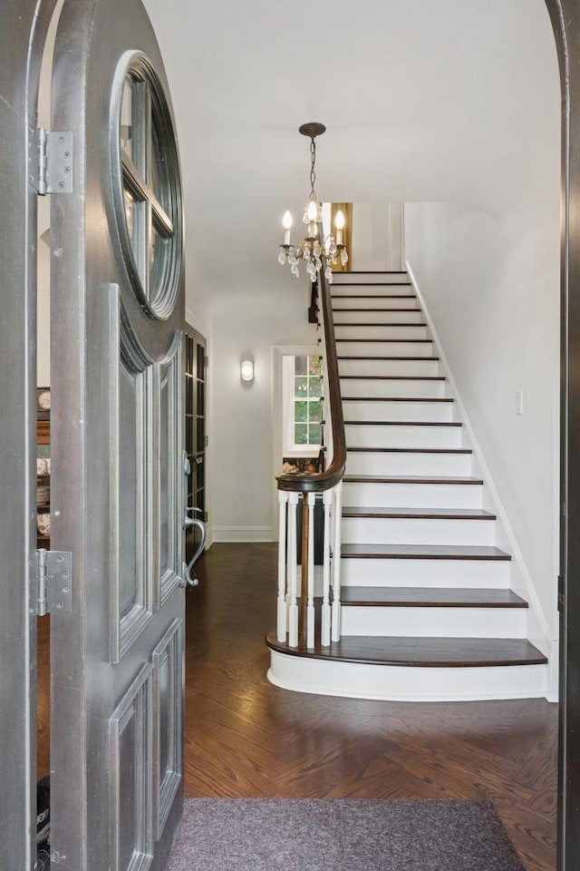 3045 W Ardmore Ave, Chicago, IL 60659 - stairway featuring a chandelier and wood finished floors