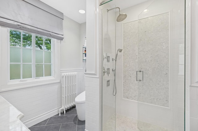 3045 W Ardmore Ave, Chicago, IL 60659 - bathroom featuring radiator heating unit, tile patterned floors, a stall shower, a wainscoted wall, and vanity