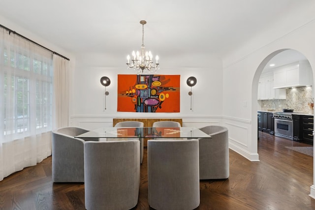 3045 W Ardmore Ave, Chicago, IL 60659 - dining room featuring a chandelier, wainscoting, arched walkways, and a decorative wall
