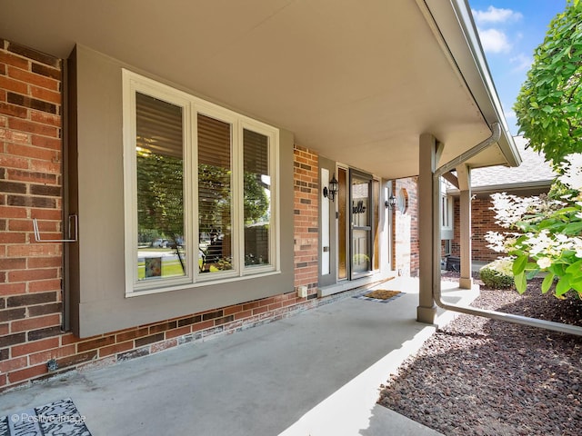 8228 W 140th St Unit 8228, Orland Park, IL 60462 - view of exterior entry featuring brick siding and a porch