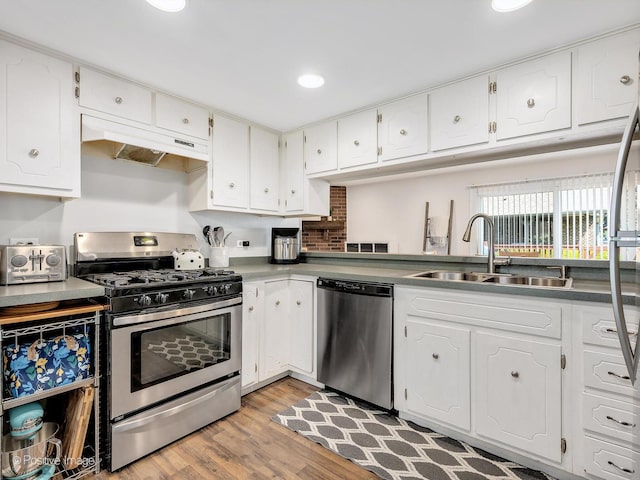 8228 W 140th St Unit 8228, Orland Park, IL 60462 - kitchen with appliances with stainless steel finishes, custom exhaust hood, light wood-style flooring, white cabinetry, and recessed lighting