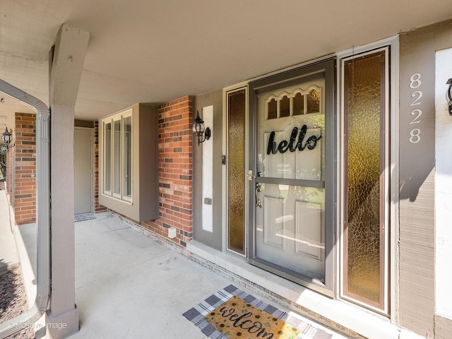 8228 W 140th St Unit 8228, Orland Park, IL 60462 - view of exterior entry featuring brick siding and a porch
