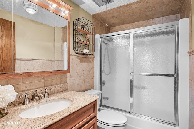1423 Woodbridge Rd Unit 2C, Joliet, IL 60436 - bathroom featuring vanity, tile walls, and shower / bath combination with glass door