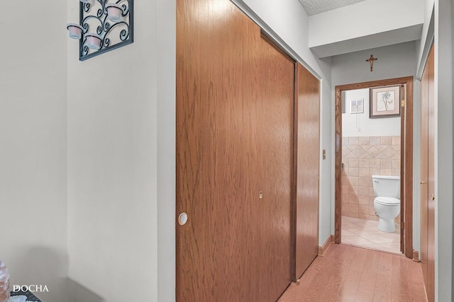 1423 Woodbridge Rd Unit 2C, Joliet, IL 60436 - hallway featuring light wood-style flooring and tile walls