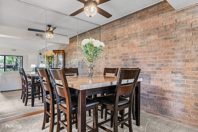 1423 Woodbridge Rd Unit 2C, Joliet, IL 60436 - dining area featuring ceiling fan, carpet flooring, and brick wall
