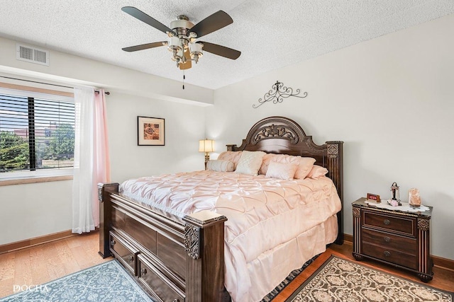 1423 Woodbridge Rd Unit 2C, Joliet, IL 60436 - bedroom with wood finished floors, a textured ceiling, and ceiling fan