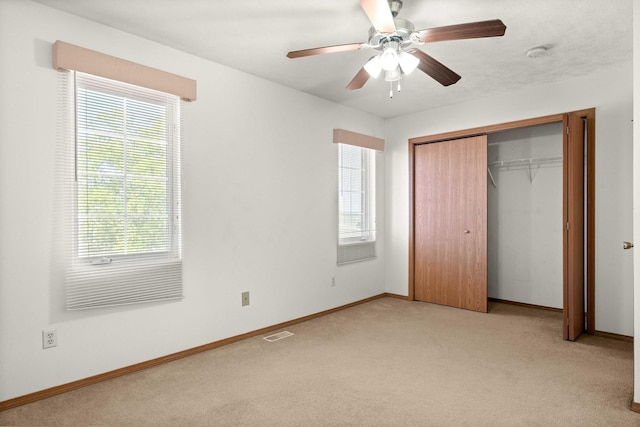 23 Fetzer Dr Unit 3, Bloomington, IL 61704 - unfurnished bedroom with light carpet, multiple windows, a closet, and a ceiling fan