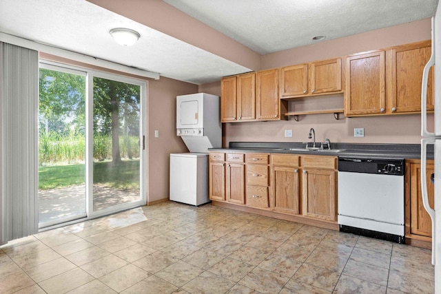 23 Fetzer Dr Unit 3, Bloomington, IL 61704 - kitchen featuring white dishwasher, stacked washer / dryer, dark countertops, a textured ceiling, and open shelves