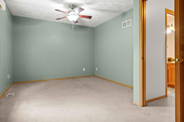 23 Fetzer Dr Unit 3, Bloomington, IL 61704 - spare room with light colored carpet, ceiling fan, and a textured ceiling