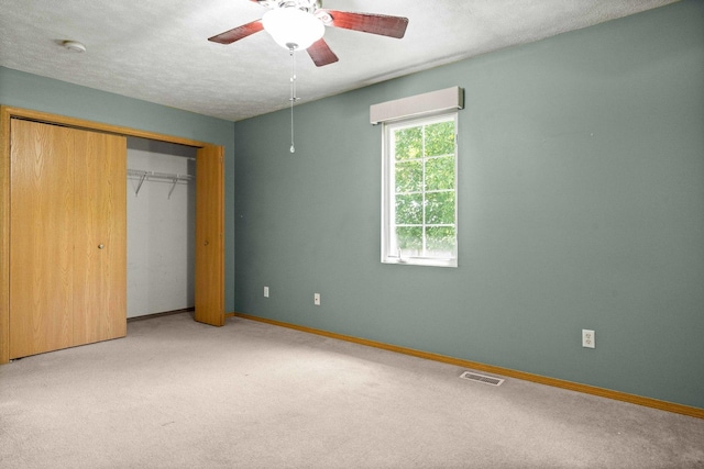 23 Fetzer Dr Unit 3, Bloomington, IL 61704 - unfurnished bedroom featuring carpet floors, a closet, and a ceiling fan