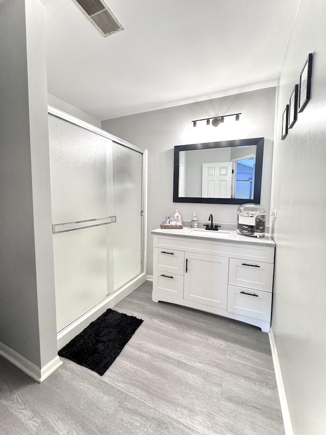 3125 Anton Dr Unit 3125, Aurora, IL 60504 - bathroom featuring wood finished floors, vanity, and a stall shower