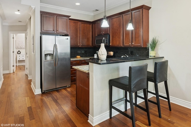 4507 N Paulina St Unit 2S, Chicago, IL 60640 - kitchen with stainless steel appliances, a peninsula, ornamental molding, a breakfast bar area, and backsplash