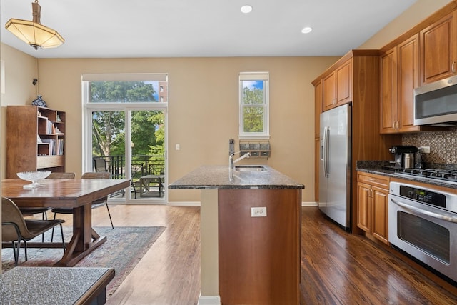 743 W 15th St, Chicago, IL 60607 - kitchen featuring appliances with stainless steel finishes, dark stone countertops, plenty of natural light, decorative backsplash, and recessed lighting