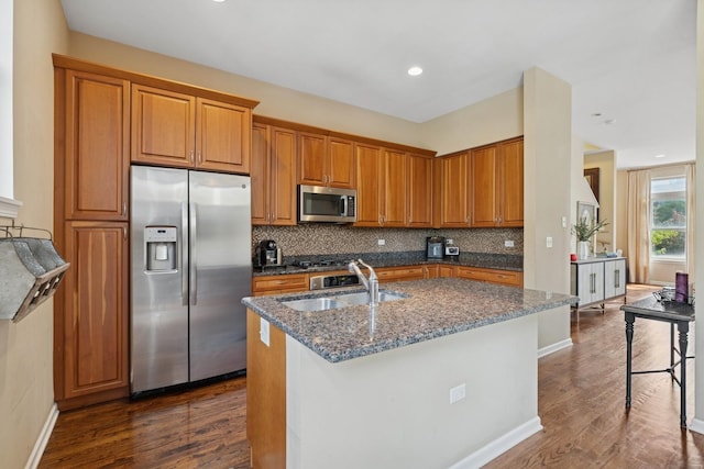 743 W 15th St, Chicago, IL 60607 - kitchen featuring stainless steel appliances, brown cabinetry, a kitchen island with sink, tasteful backsplash, and recessed lighting