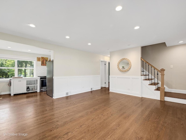 19 Indian Dr, Clarendon Hills, IL 60514 - unfurnished living room with stairs, wood finished floors, a wainscoted wall, recessed lighting, and a decorative wall