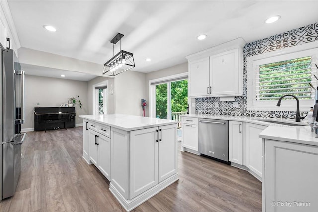 746 Parker Ct, Geneva, IL 60134 - kitchen with appliances with stainless steel finishes, a kitchen island, light wood-style flooring, white cabinets, and recessed lighting