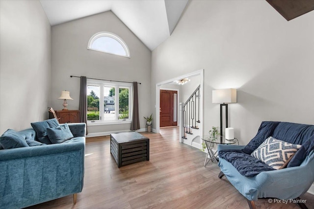 746 Parker Ct, Geneva, IL 60134 - living area with plenty of natural light, stairs, wood finished floors, high vaulted ceiling, and a chandelier