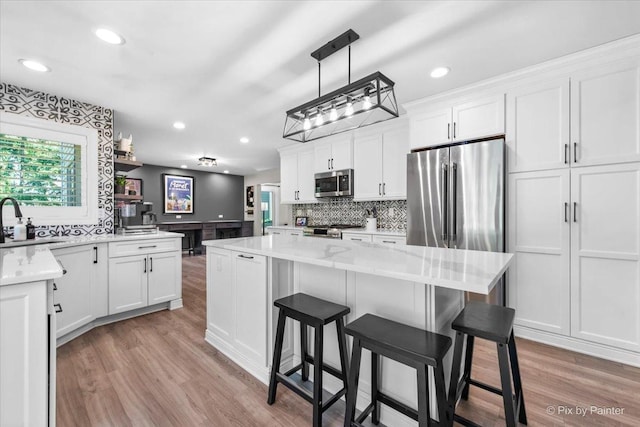746 Parker Ct, Geneva, IL 60134 - kitchen featuring stainless steel appliances, decorative backsplash, light wood-style floors, plenty of natural light, and recessed lighting