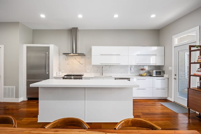 1123 W 19th St, Chicago, IL 60608 - kitchen with built in fridge, modern cabinets, wall chimney range hood, light countertops, and recessed lighting